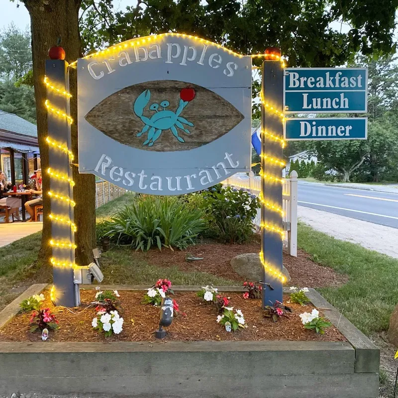 The Crabapples Restaurant sign, strung with lights, listing Breakfast, Lunch and Dinner