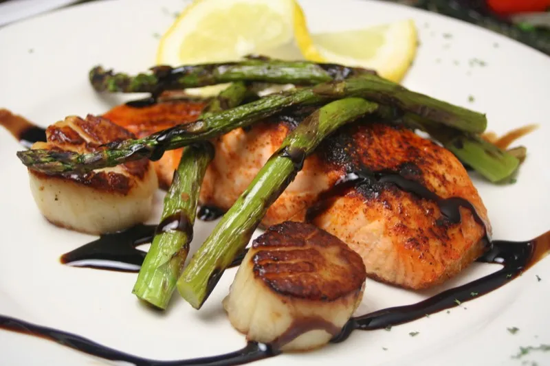Seared scallops and salmon with asparagus and balsamic glaze