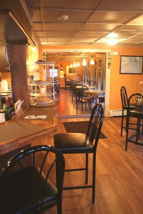 Bar counter and stools at the end of the dining room