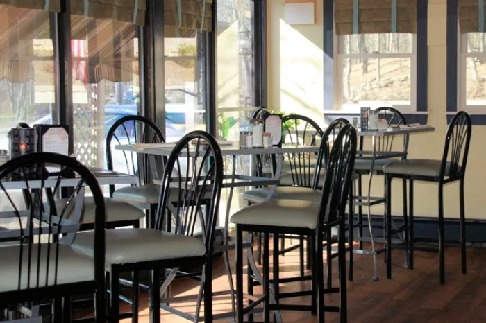 Bright dining room with bistro chairs and large windows